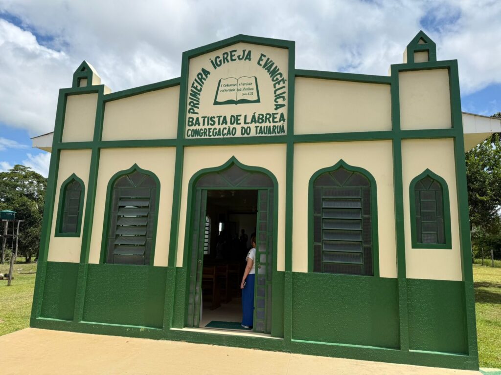A small green and cream evangelical church building in Brazil