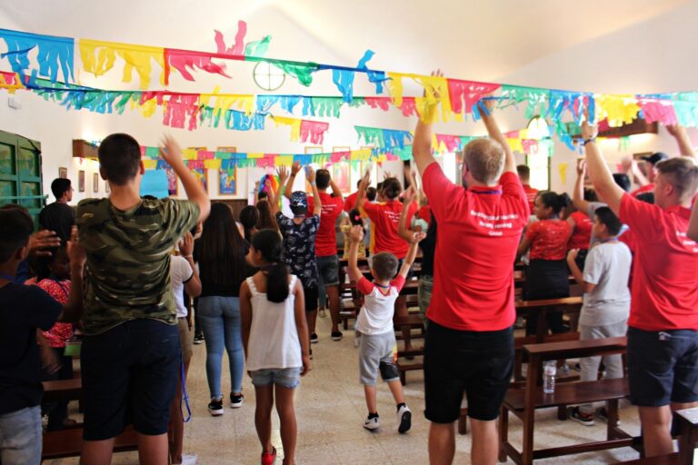 An Acre mission team leading a children’s club in a church hall